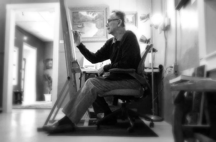 Alberto Escamilla painting at the easel in his studio